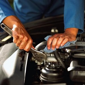 A mechanic fixing a car engine