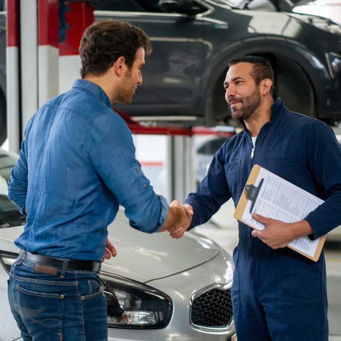 mechanic shaking hands with client