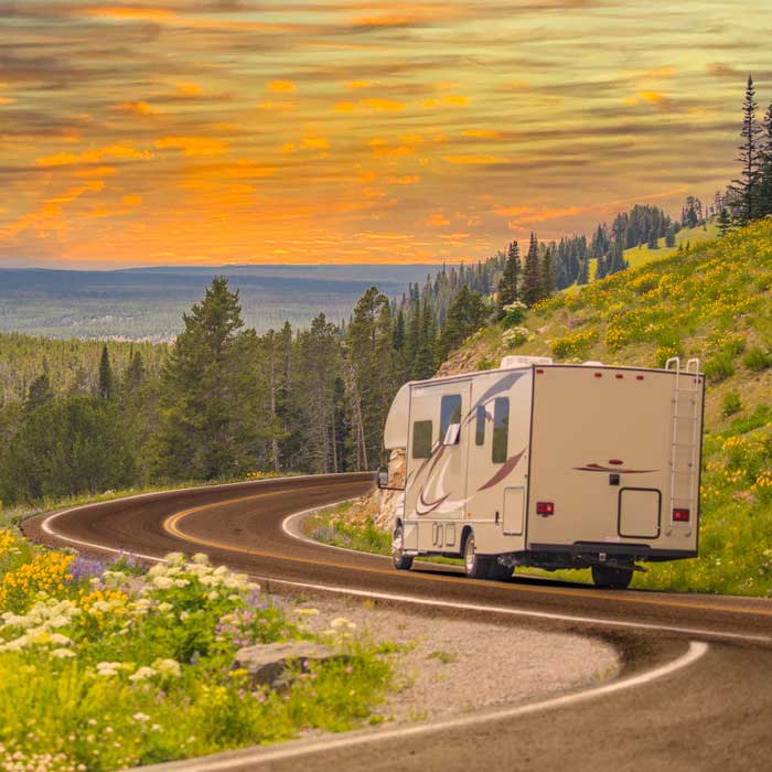 RV driving down winding road